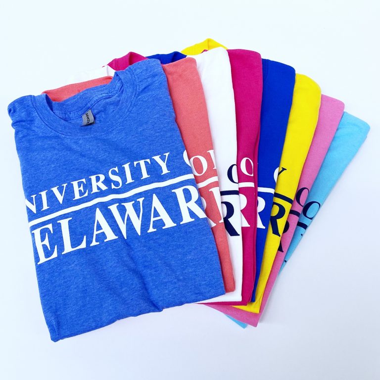 Pile of University of Delaware Skittles Short Sleeve T-shirts in Assorted Bright Colors
