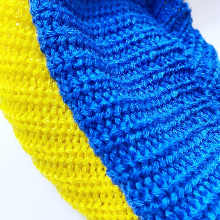 Detail of blue and yellow knit infinity scarf